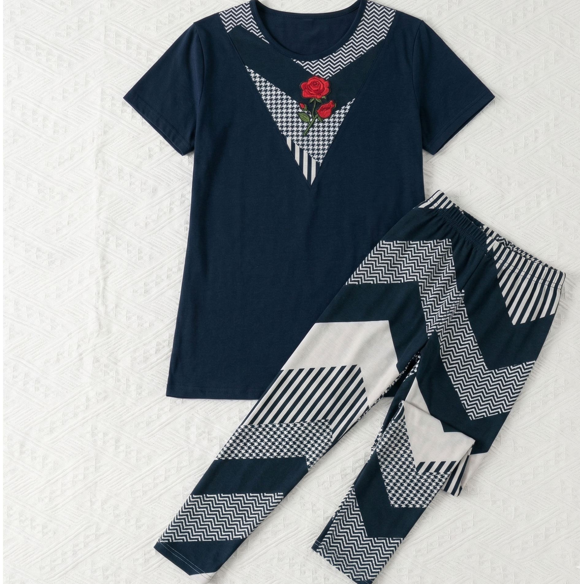 Navy blue pajama set with geometric patterns on a white background